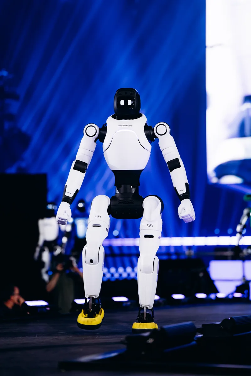 AGIBOT X2 robot mid-dance-move on stage at the LoveTomorrow event