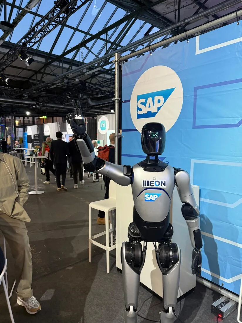 ILLEON A2 Ultra waving in front of an SAP-branded backdrop at a trade fair booth